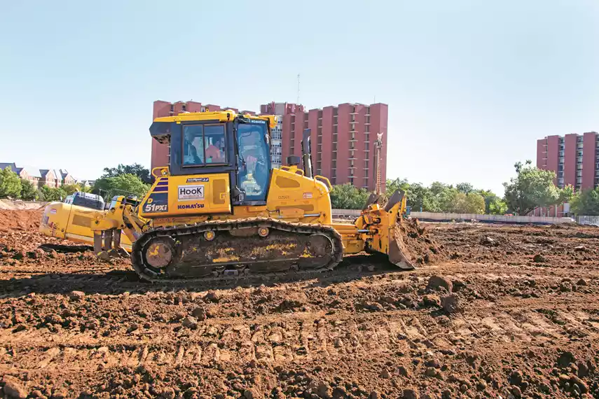 An operator grades with a Komatsu D51PXi-24 Intelligent Machine Control (IMC) dozer on a project for the University of Oklahoma in Norman, Okla. 