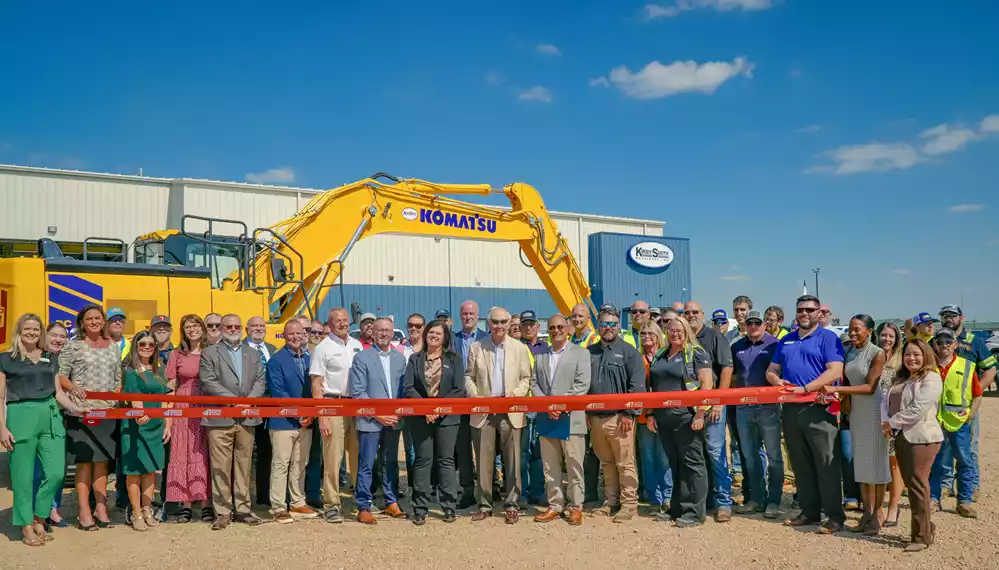 Ribbon cutting with community members and the Kirby-Smith Machinery team