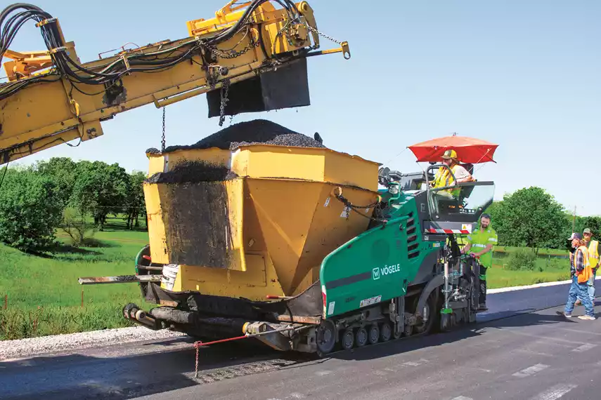 : T & G Construction paves Highway 19 between Stratford, Okla., and Ada, Okla., with a VÖGELE SUPER 1700 paver followed by a HAMM HD+ 140i high-frequency, double-drum roller for compaction.