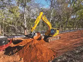 Operator Jesus Collazo digs a trench with a Komatsu PC290LCi-11 Intelligent Machine Control (IMC) excavator on a road widening project near Pawnee, Okla.